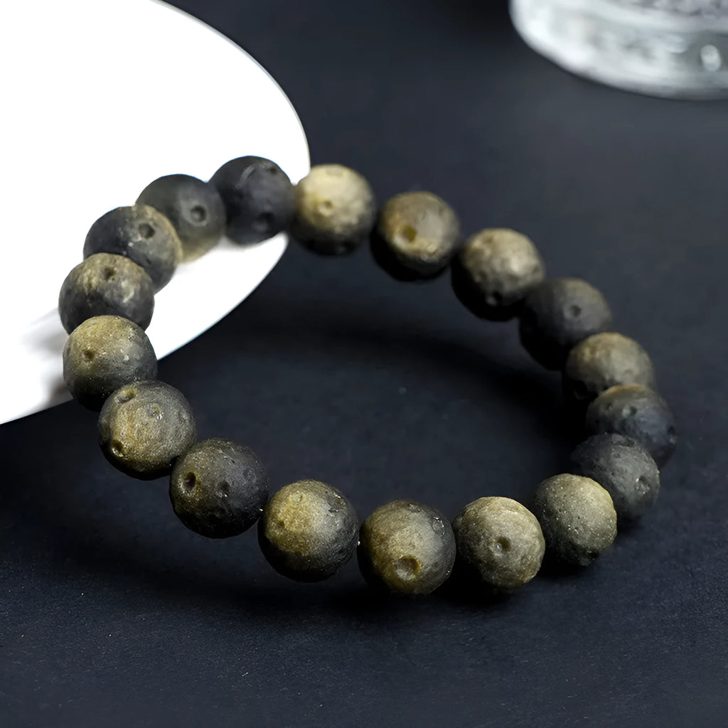 Natural obsidian crater ball bracelet with hand-ground meteorite beads in gold or silver colour options