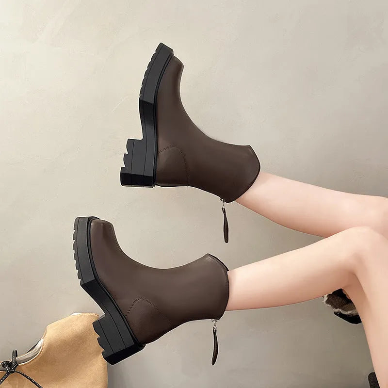 Women's black platform Martin ankle boots with a square toe and back zipper on a white background