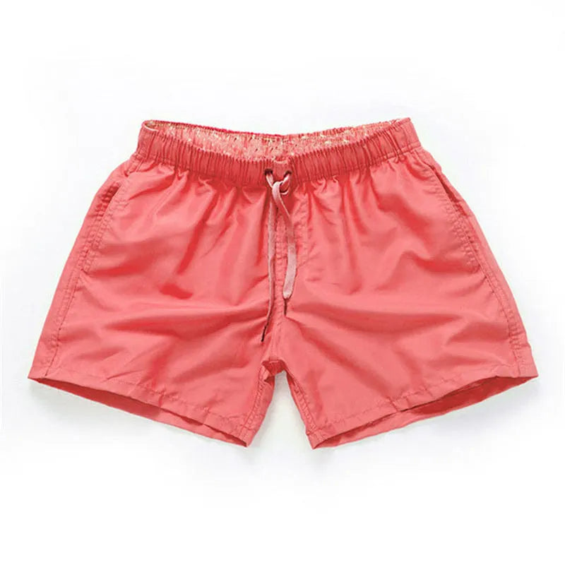 Men's straight-leg polyester beach shorts in black, shown on a model, highlighting the distressed finish and casual fit.