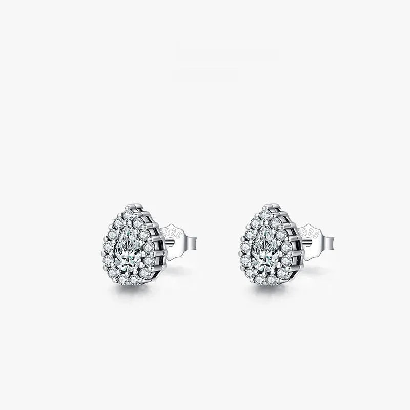 A pair of women's silver water drop shaped stud earrings on a plain background