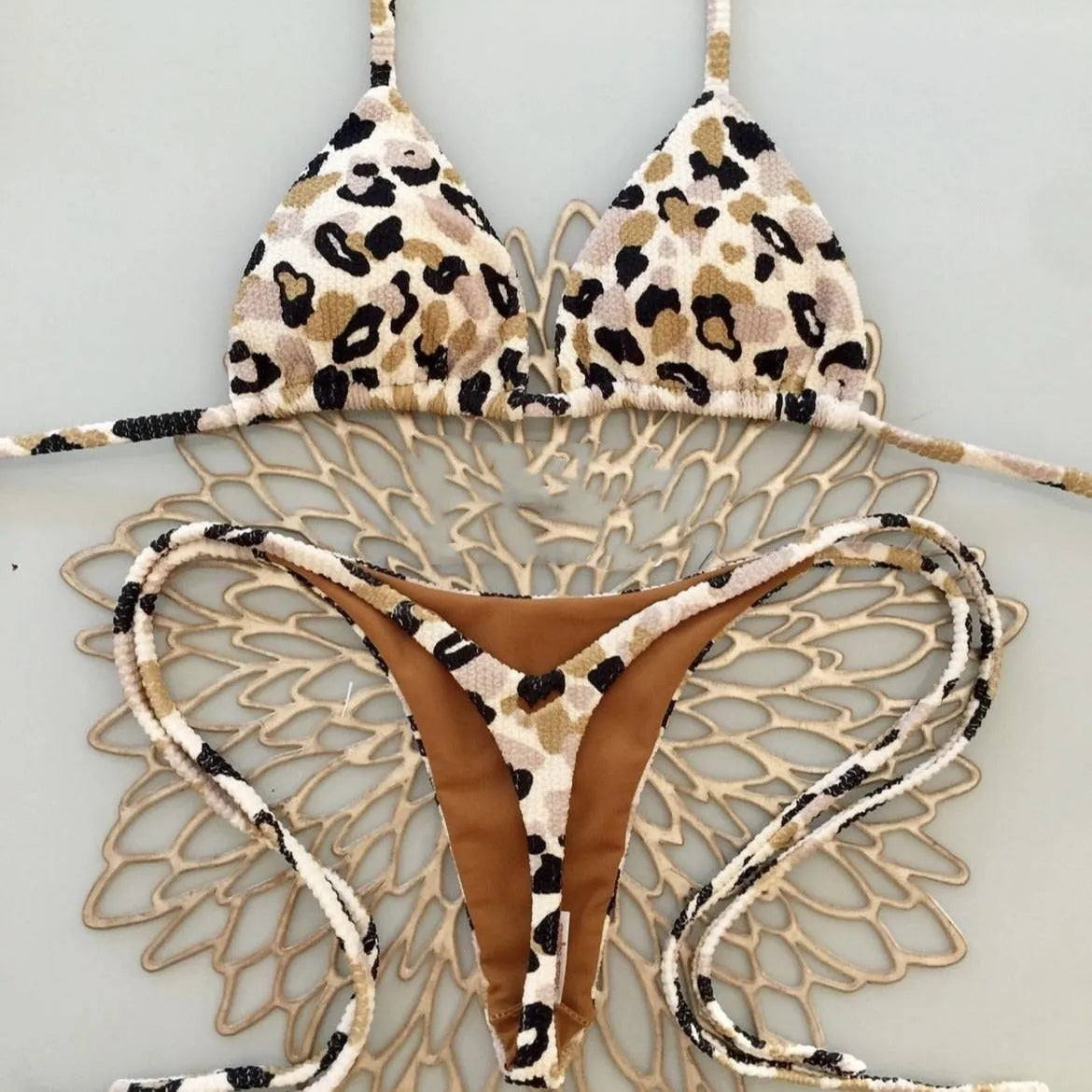Women's briefs-style bikini swimsuit in a printed pattern, made from nylon with a cotton lining.