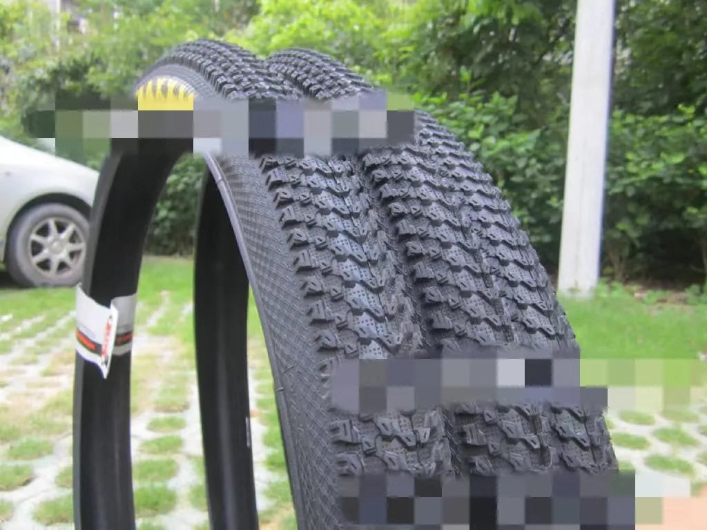 Ultralight puncture-resistant mountain bike tyre shown in black with white label option, for 26, 27.5 and 29-inch wheels.