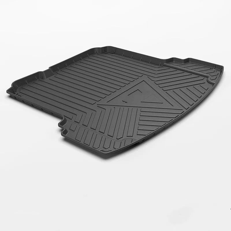 Black carbon fibre pattern TPE car trunk protector mat lying flat.