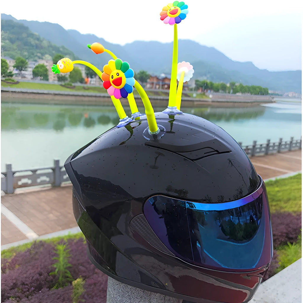 Yellow silicone sunflower decoration with a suction cup base for helmet mounting.