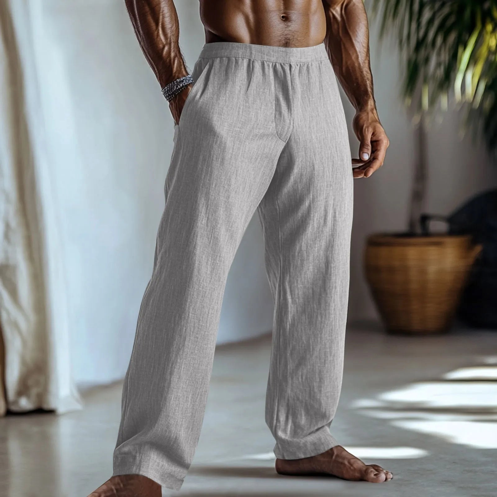 Straight leg cotton linen trousers in light apricot colour on a hanger.