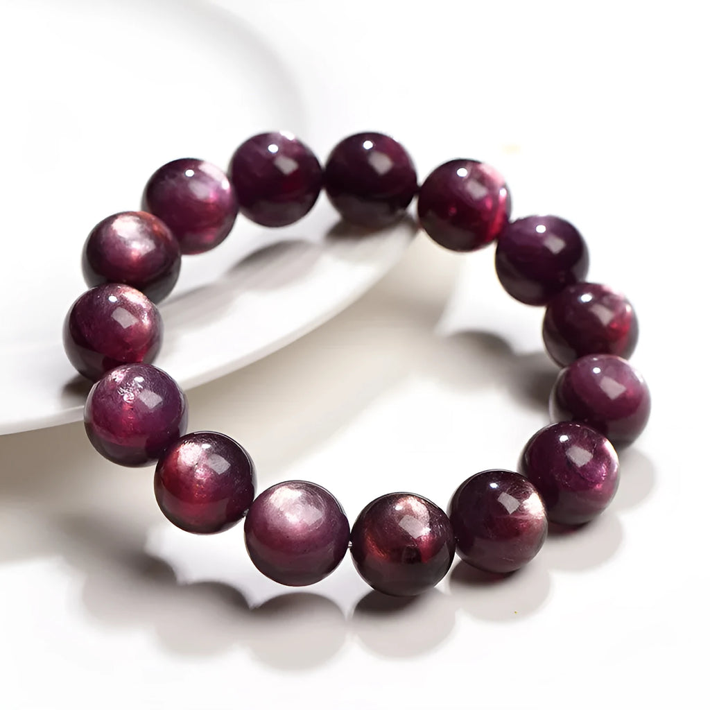 Purple lepidolite crystal round bead bracelet with polished finish on a wrist.