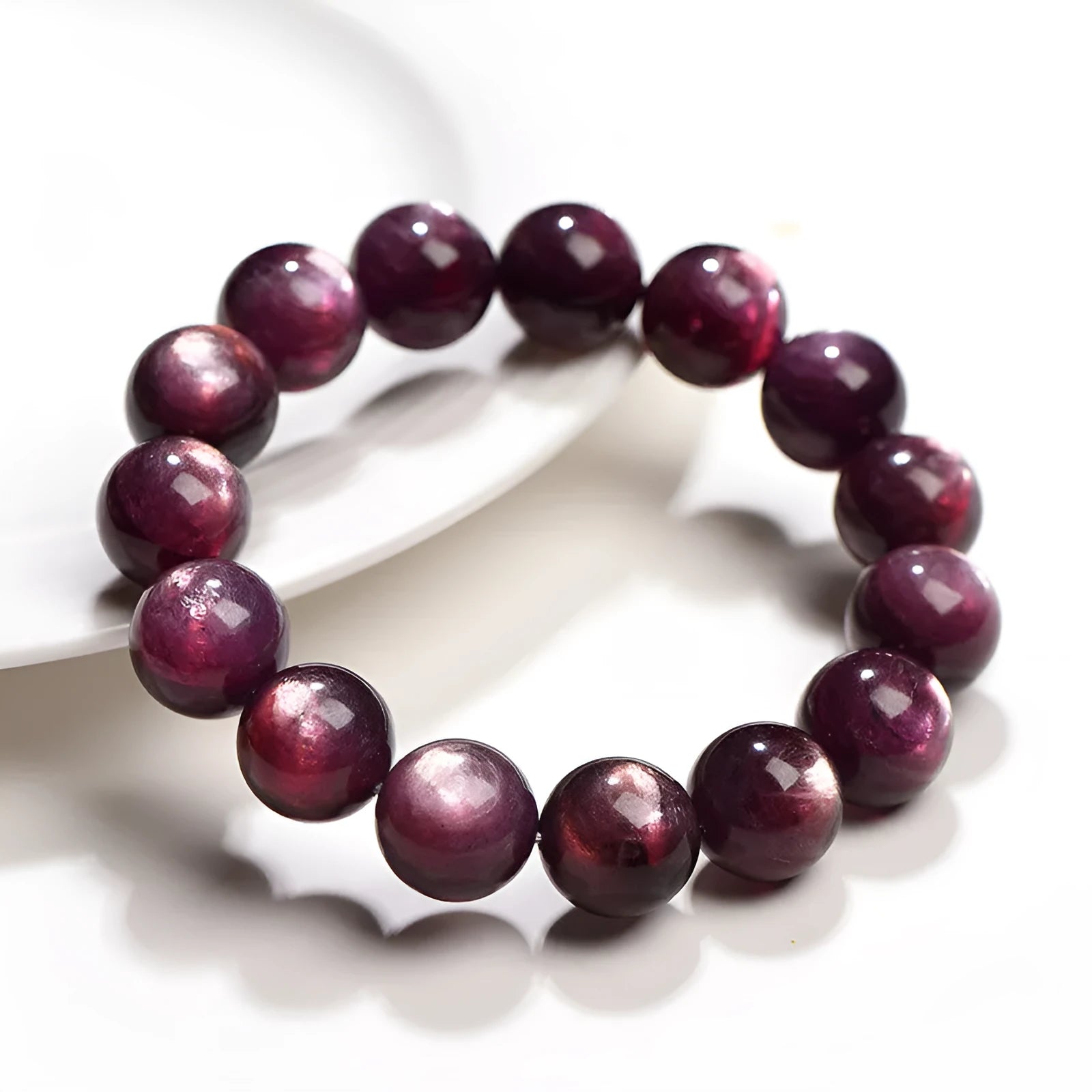 Purple lepidolite crystal round bead bracelet with polished finish on a wrist.