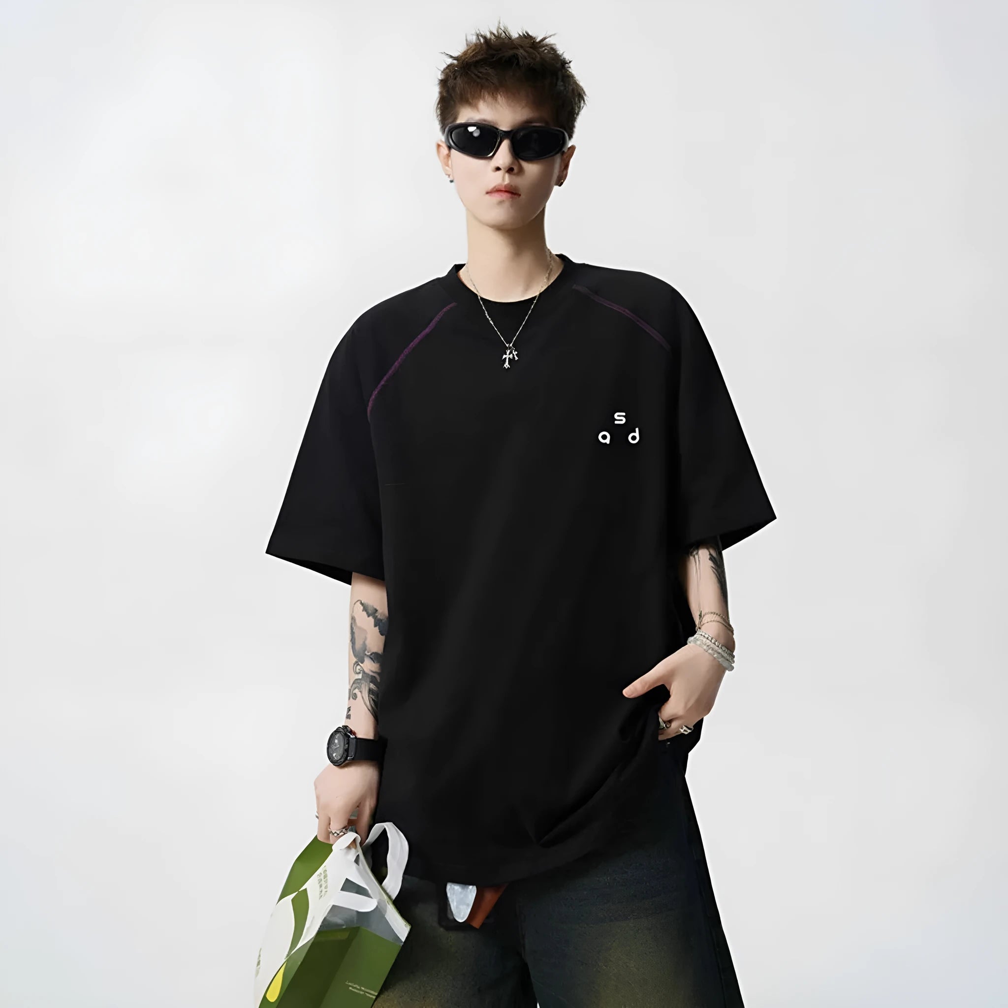 Loose fit black cotton t-shirt with white letter print, short sleeves, and round neck.