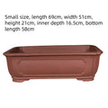 Large rectangular purple clay flowerpot shown on a patio, suitable for bonsai or large plants.