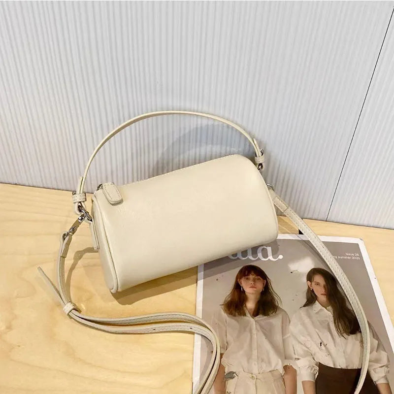 Cylindrical leather crossbody phone bag in vegetable tanned genuine leather with sewing thread detailing