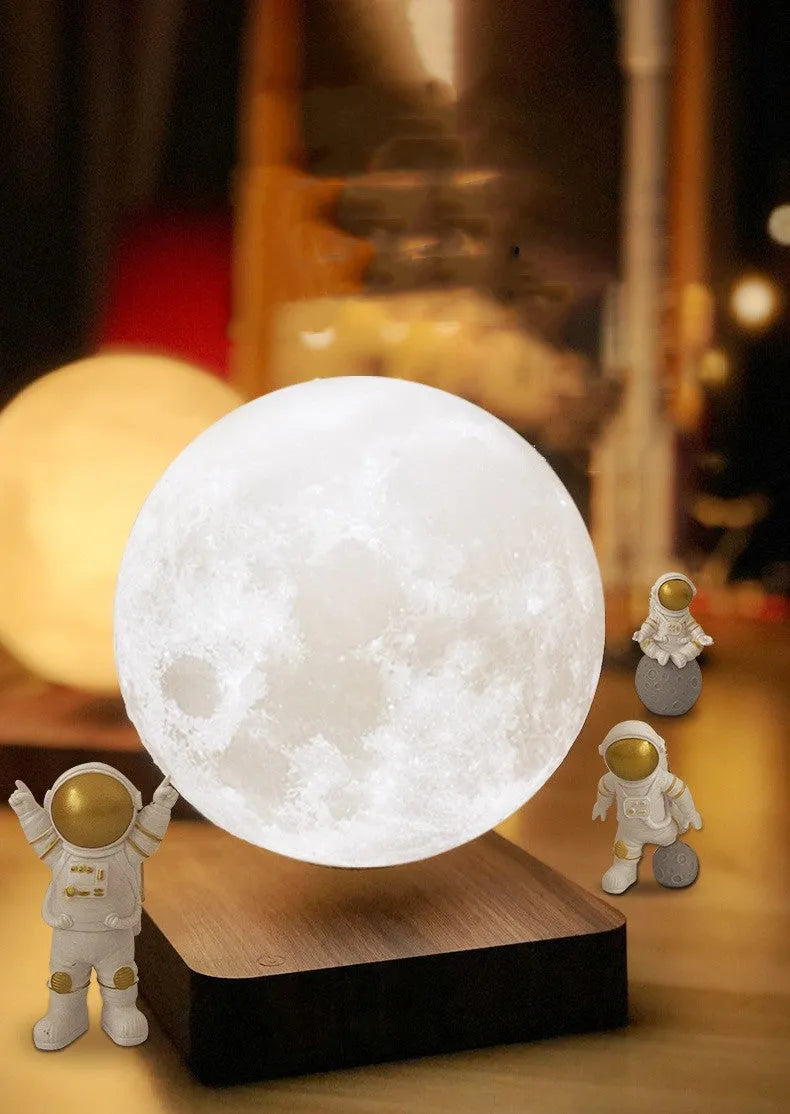 Maglev moon and planet night light floating above base with three astronaut figurines