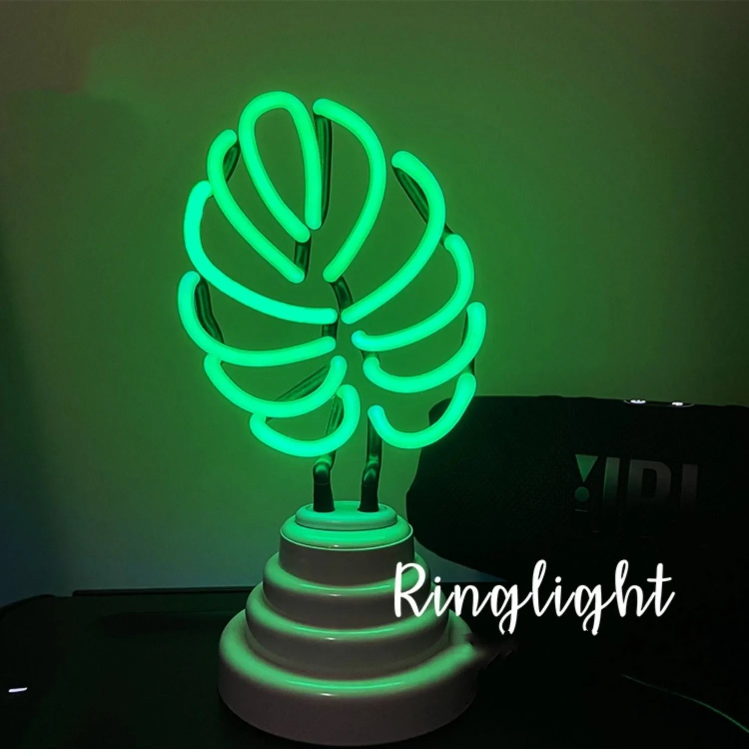 Minimalist bamboo-shaped desktop lamp with white tube emitting green light, USB powered