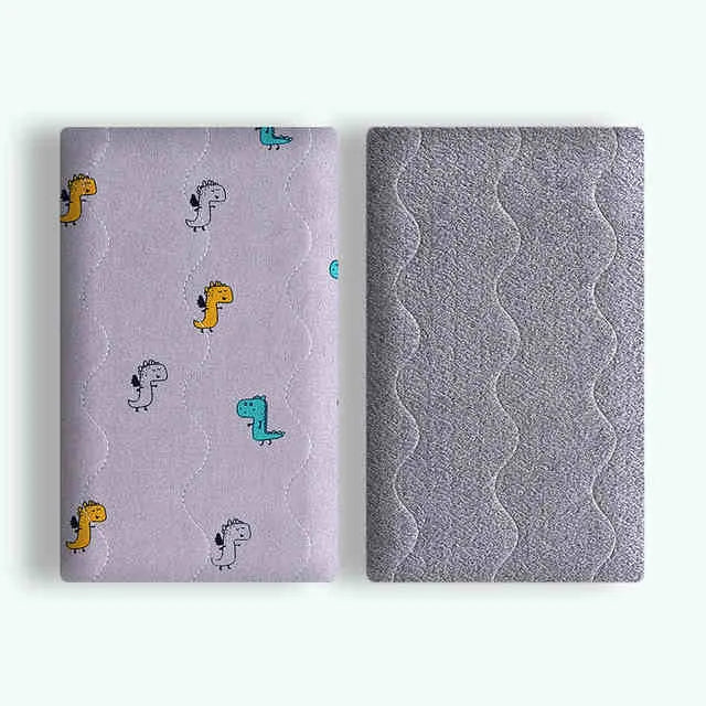 Double-sided cotton wool pet blanket with cartoon dinosaur print lying flat