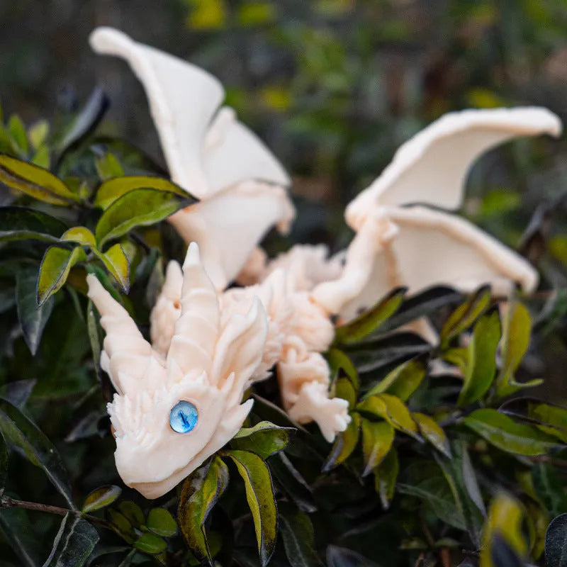 3D printed red and gold flying dragon wings decoration toy on a white background.
