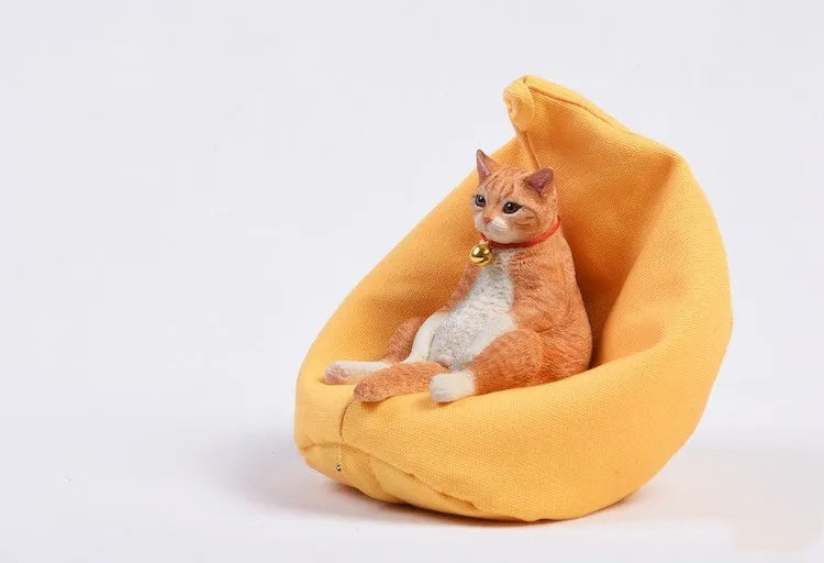 Small resin cat ornament sitting on fabric sofa for car dashboard decoration