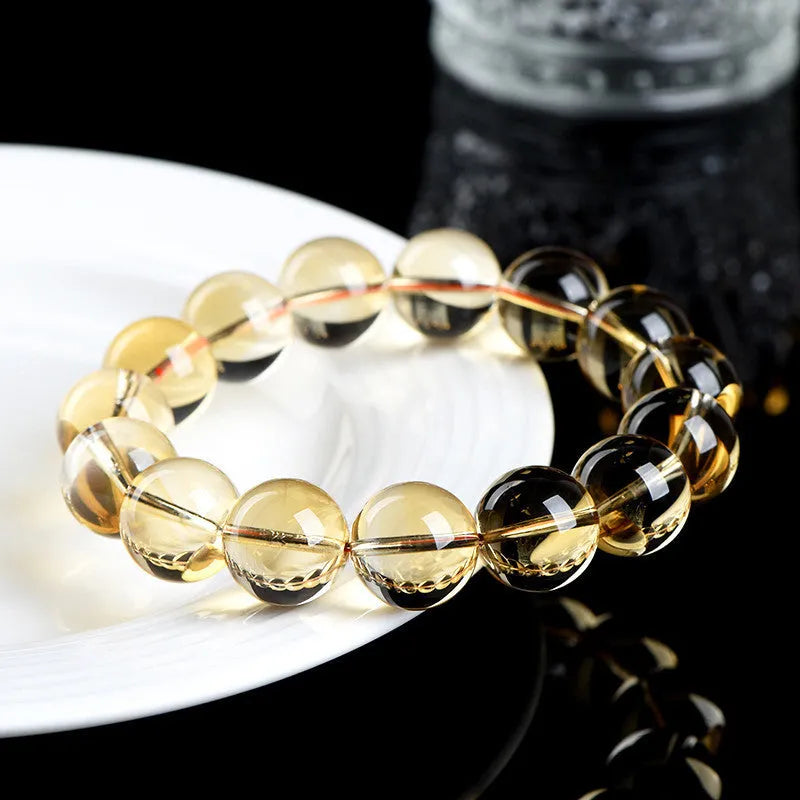 Natural citrine scattered beads ball bracelet showing polished yellow stone beads on wrist.