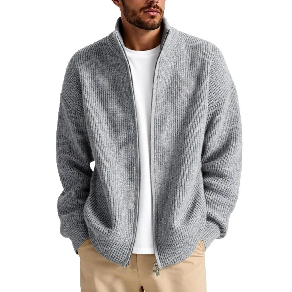 Man wearing a loose-fit grey cardigan sweater, a casual base layer for leisure wear.