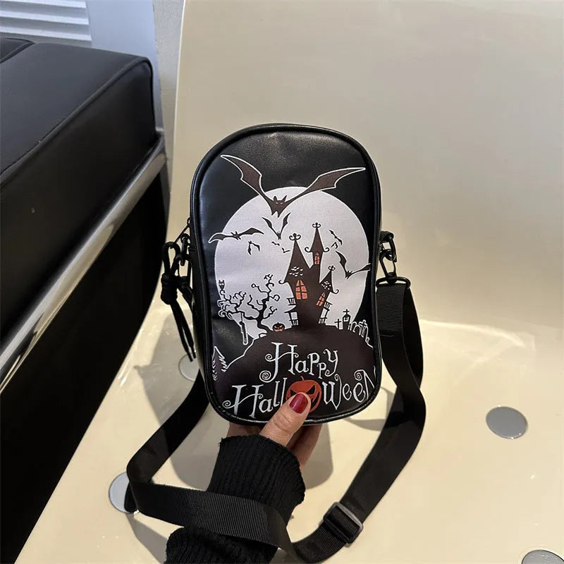 Black mini crossbody bag with Halloween cartoon print of pumpkins, ghosts, and bats.