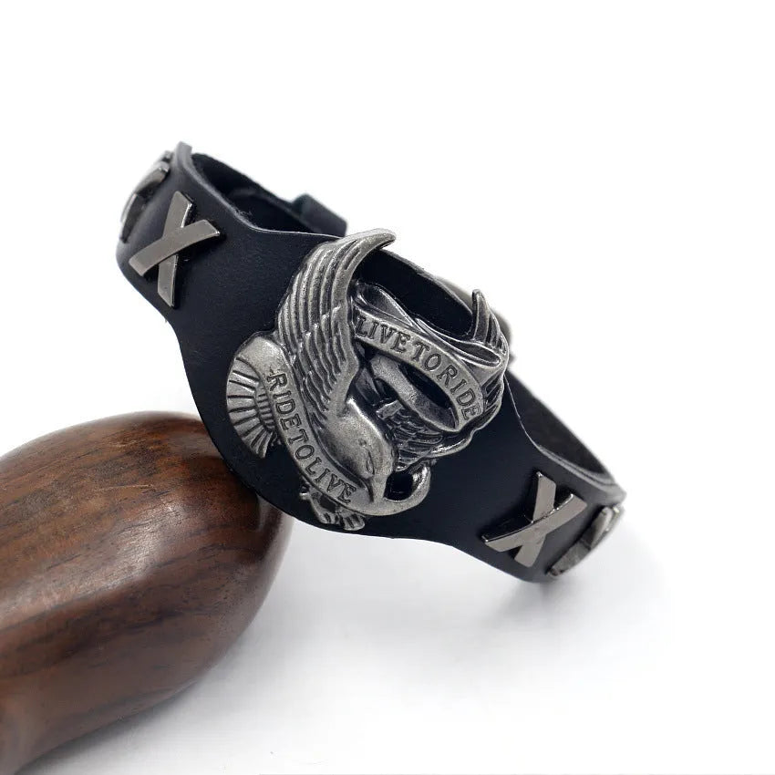 Black geometric leather bracelet with metallic eagle clasp showing 26cm length and varying width dimensions