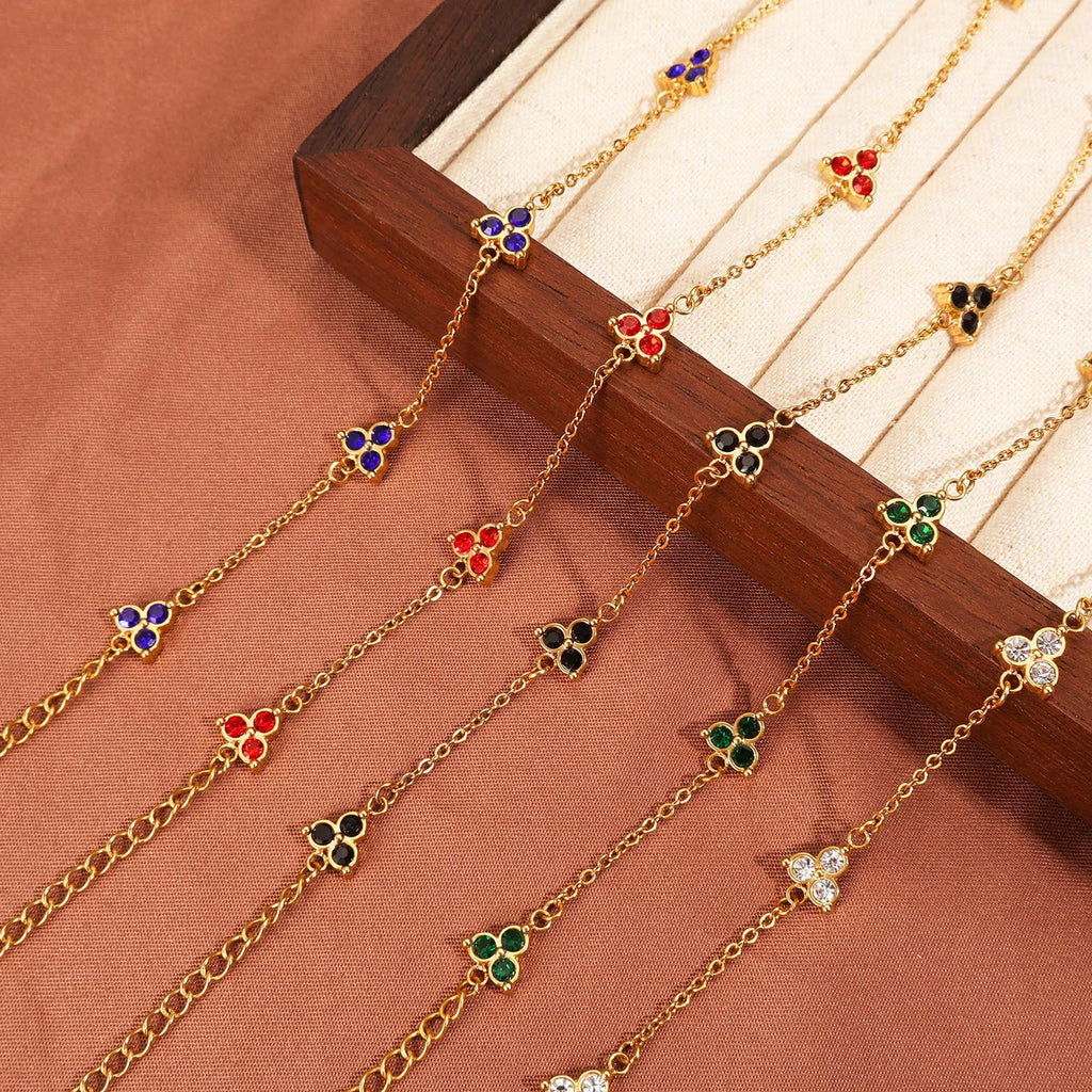 Geometric stainless steel women's bracelet with triangular links and a coloured stone centre.