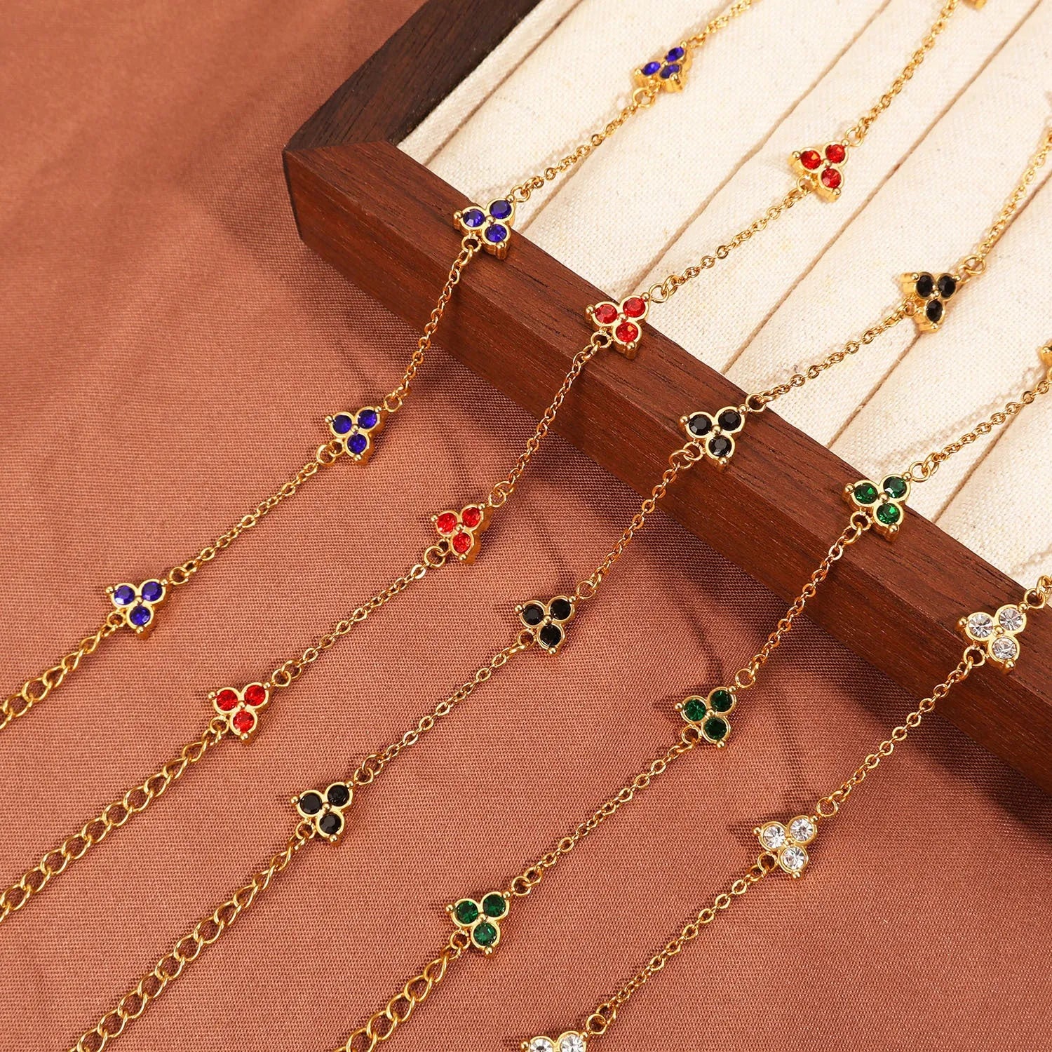 Geometric stainless steel women's bracelet with triangular links and a coloured stone centre.