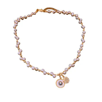 Gold electroplated necklace with round imitation pearl pendant and zircon detailing on adjustable clavicle chain