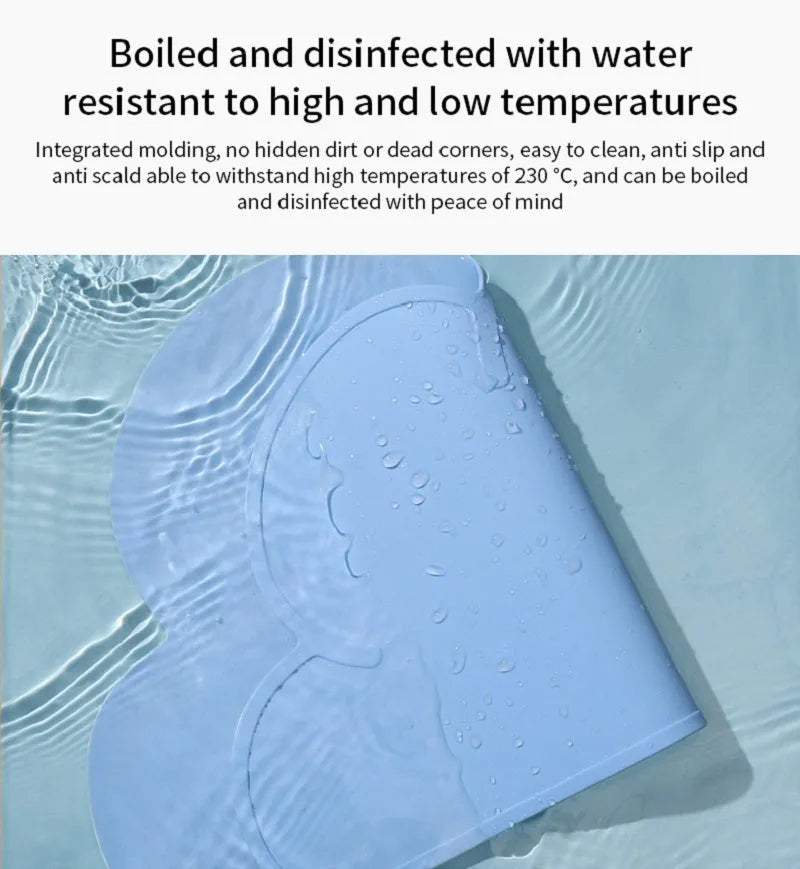 Blue silicone pet feeding mat for dog or cat bowls on a wooden floor.