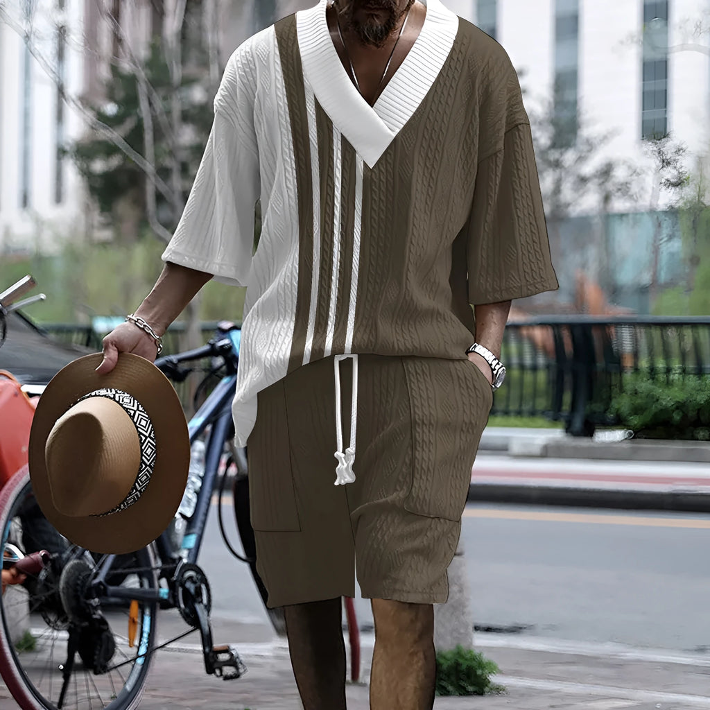 Man wearing a printed drop-shoulder knitted short-sleeve top and matching shorts in a casual setting.