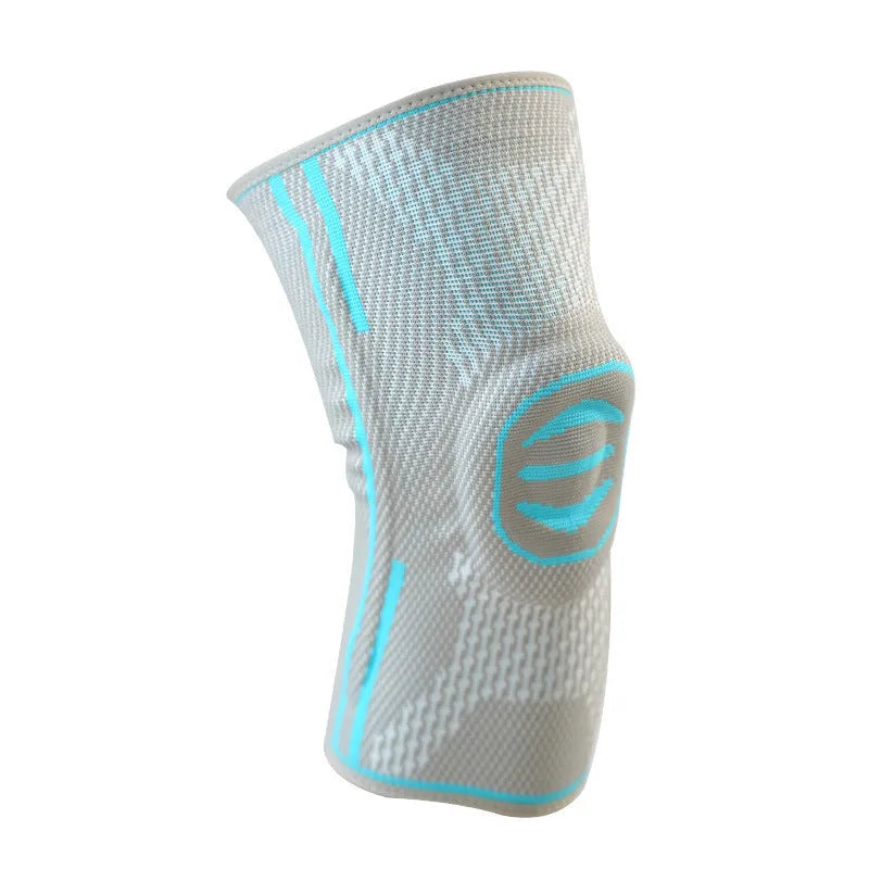 A pair of cotton mountaineering knee pads in blue, shown on a knee.