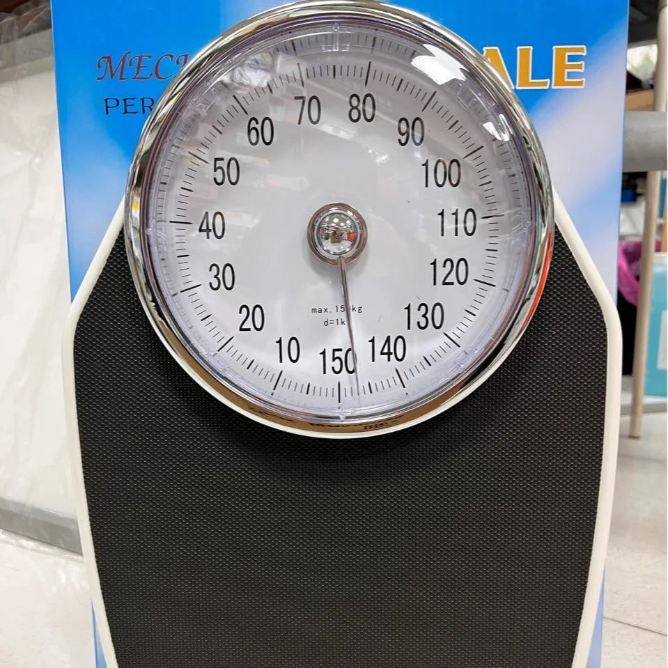 Black mechanical pointer body weight scale with large dial on a simple platform.