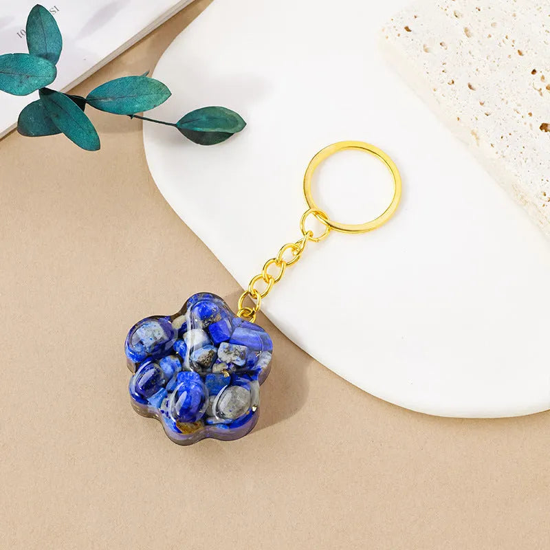 Small natural crystal cat's paw pendant on a metal keyring, available in various stone colours.