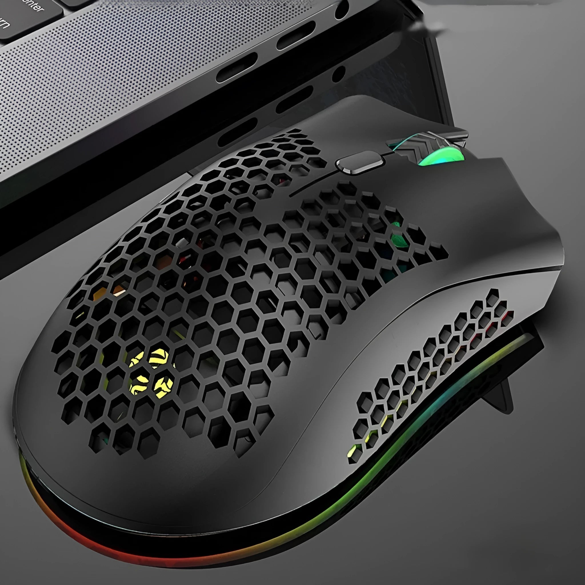 BM600 hollow out wireless gaming mouse with RGB lights in cyan colour on a desk