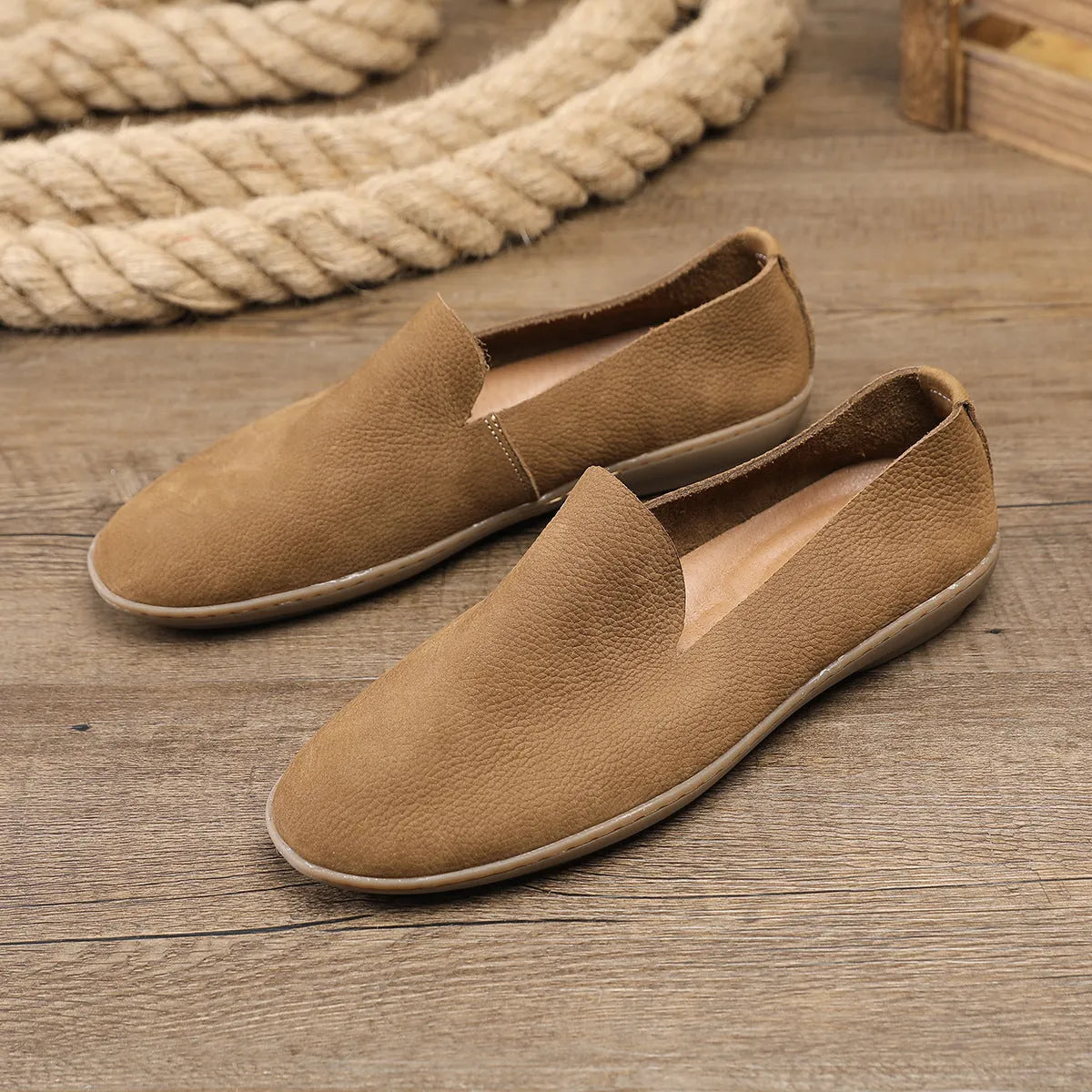 Handmade grey low-top men's casual shoes with a wedge heel and rubber sole on a white background.