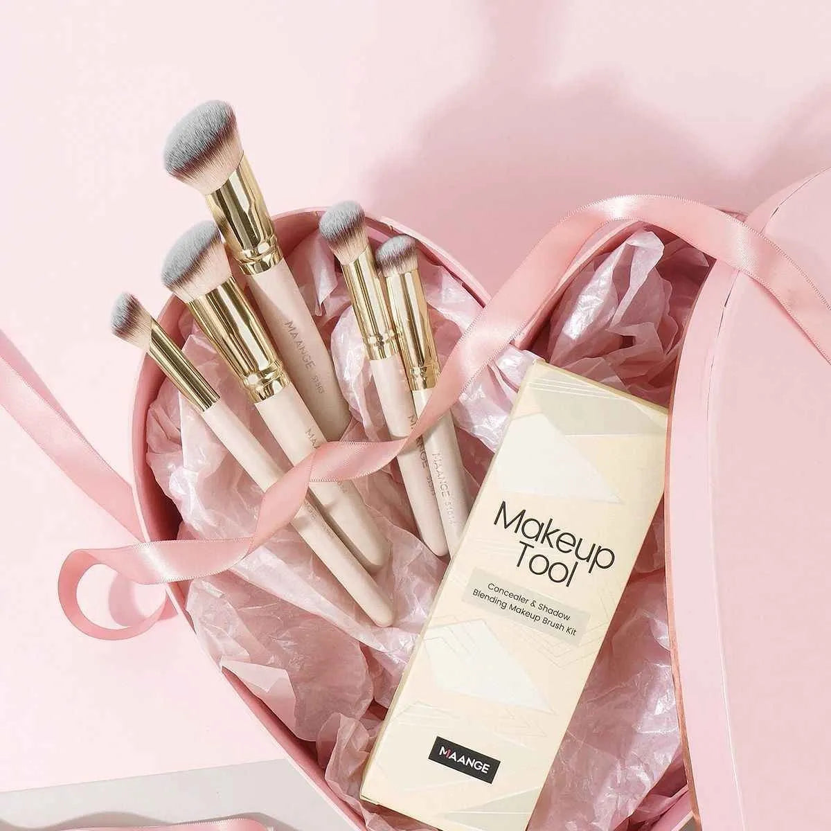 Five apricot coloured makeup brushes with angled blush brush design on white background