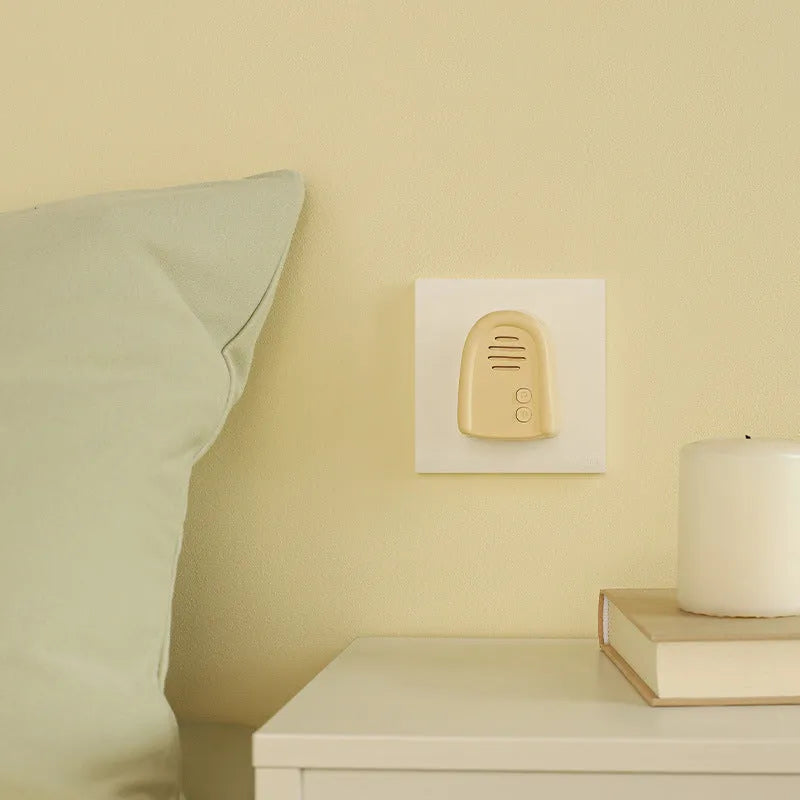 Wireless plug-in beeper doorbell in milky yellow or white colour for household use.