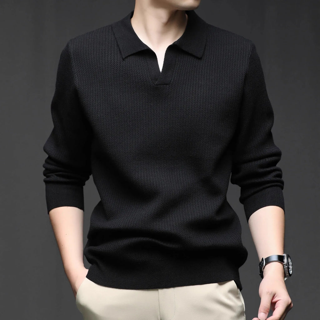 Man wearing a loose green pullover sweater, a casual autumn bottoming layer.