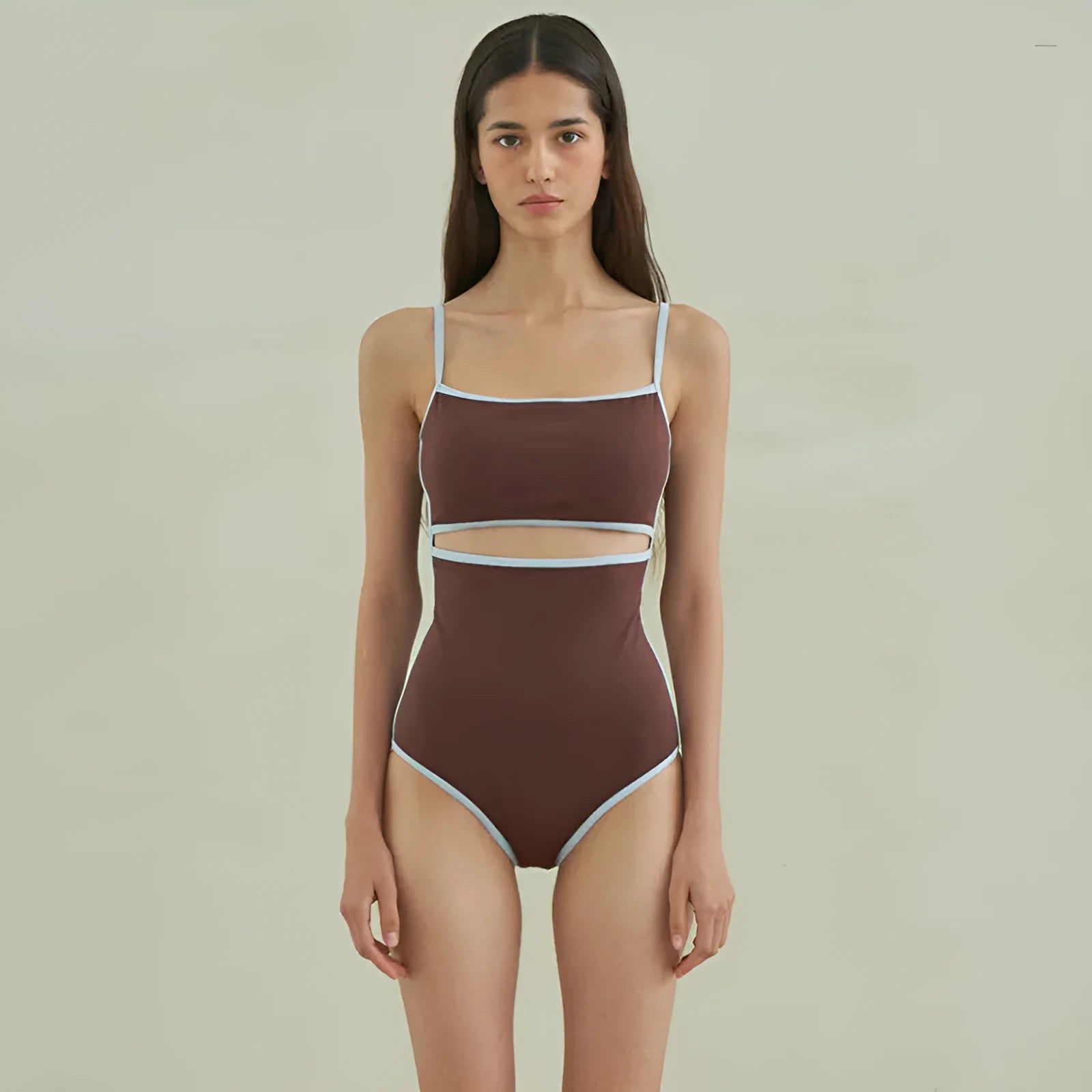 Brown triangle one-piece swimsuit for women on a hanger, showing front design.