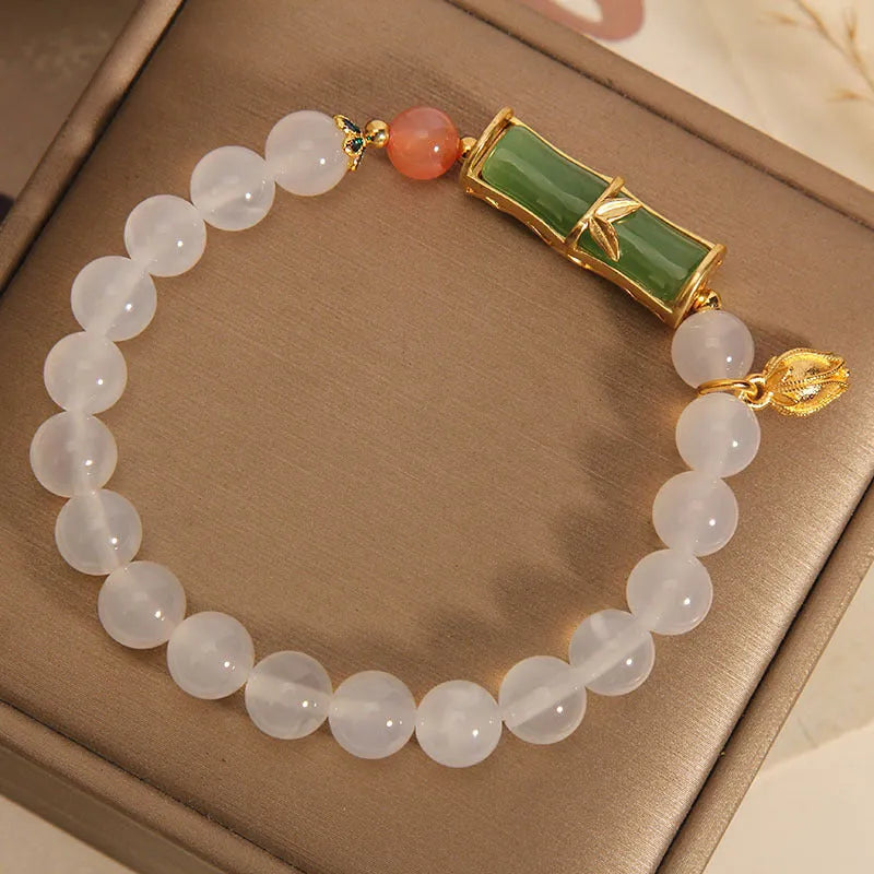 White agate and jade bamboo beaded bracelet with jasper accents on a neutral background.