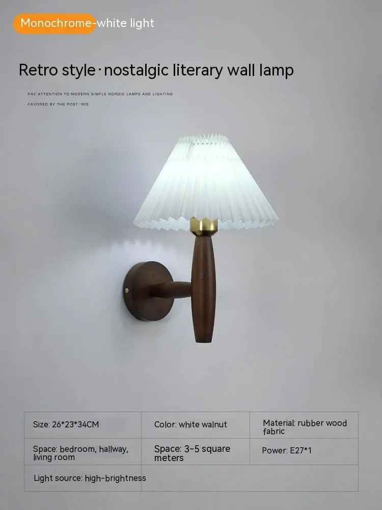 American retro style wall lamp with a walnut wood base and white fabric shade mounted on a wall.
