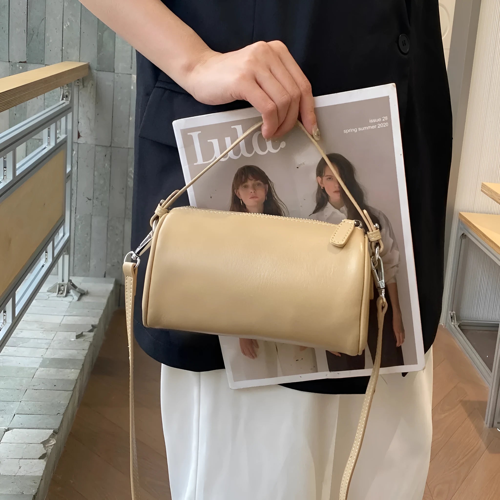 Cylindrical leather crossbody phone bag in vegetable tanned genuine leather with sewing thread detailing