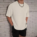 Men's loose slim fit solid colour short sleeve T-shirt in light blue on a grey background.