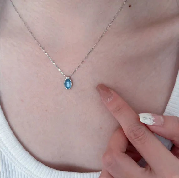 Navy blue water drop necklace with geometric design on adjustable cross chain