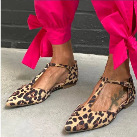 Leopard print women's court shoes with a pointed toe, cross shoulder strap, and a low chunky heel.
