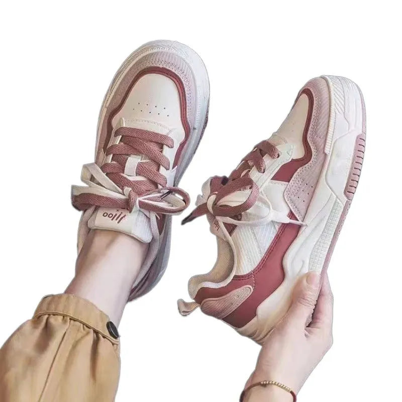 Beige and pink low-top sneakers with rubber soles and imitation leather lining