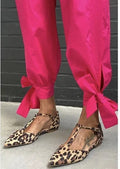 Leopard print women's court shoes with a pointed toe, cross shoulder strap, and a low chunky heel.