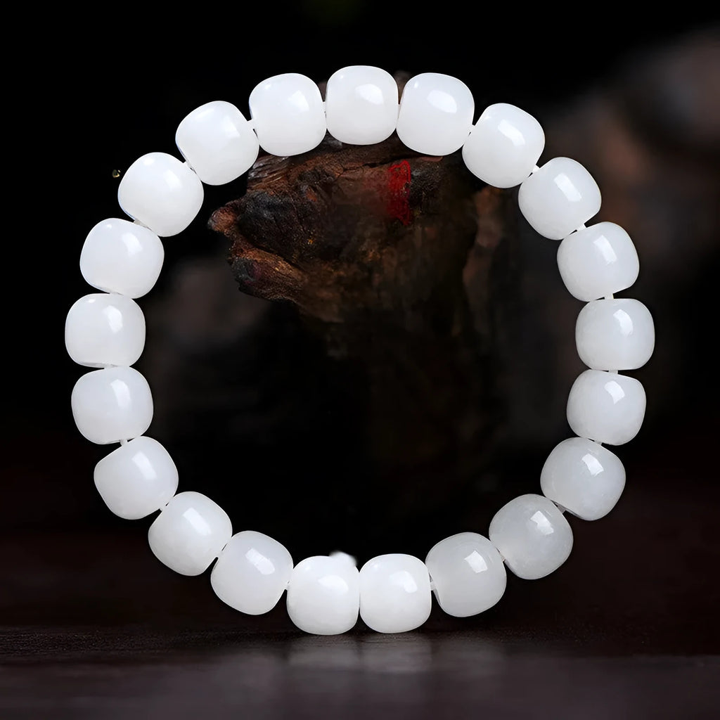 White Hetian jade barrel bead bracelet showing smooth polished beads on wrist