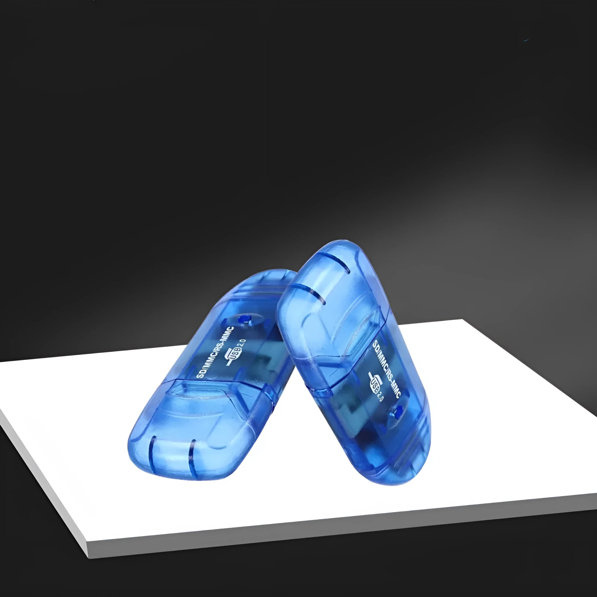 Transparent USB card reader with optional LED light on a desk next to memory cards.