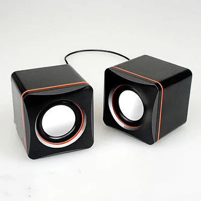 Small black square computer speaker with USB cable for desktop audio