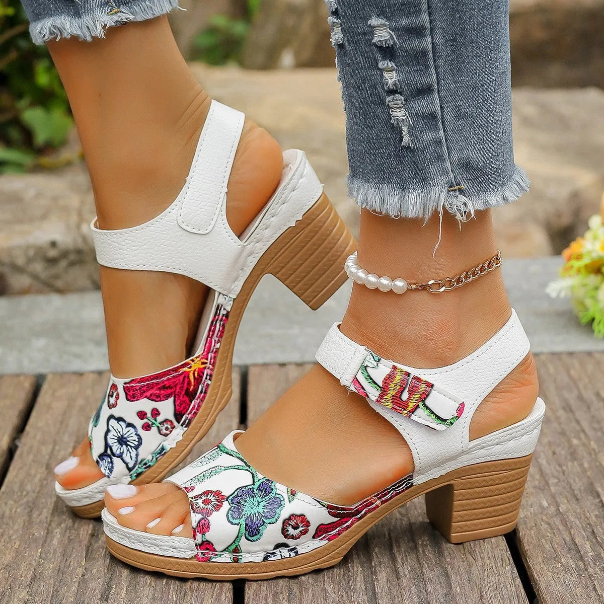 White women's high heel sandals with a Velcro strap closure on a rubber sole.