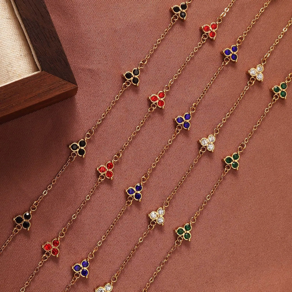 Geometric stainless steel women's bracelet with triangular links and a coloured stone centre.